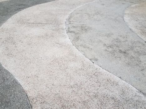 white and grey curved cement sidewalk or ground or floor