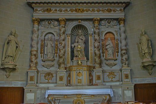 Altar with statues of saints in Catholic cathedral at Avranches, France