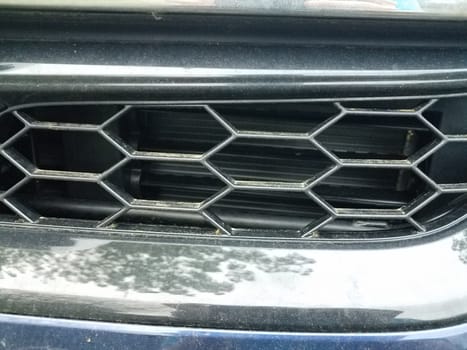 metal hexagonal grill on front of car or automobile