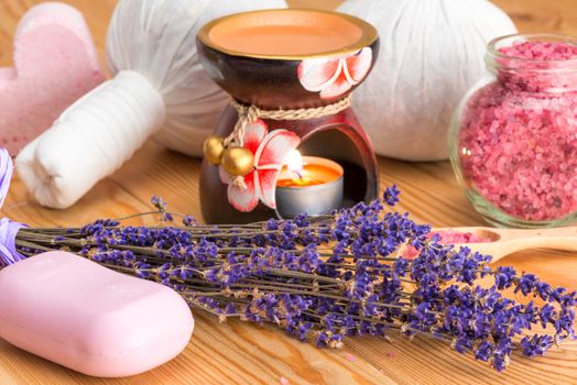 natural lavender cosmetics for spa treatments and candle in aroma lamp close-up objects