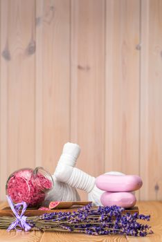 jar of sea salt with lavender, soap and herbal massage bags spa objects