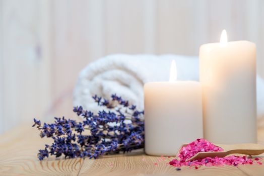 closeup of sea salt with lavender and burning candles spa procedures