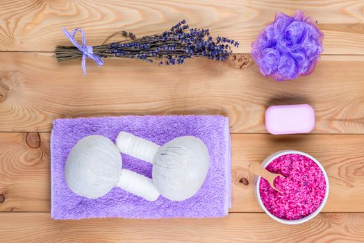 Lavender on wooden planks and cosmetics for massage, relaxation and spa treatments top view