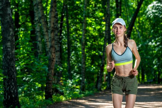 portrait of a female runner in a summer park