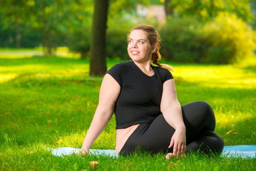 portrait of a plus size model in the park during a yoga class, stretching exercise