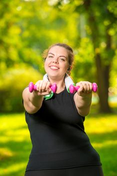 overweight woman doing her exercise in the park, exercise with dumbbells