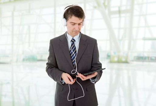 businessman with tablet pc and headphones, at the office