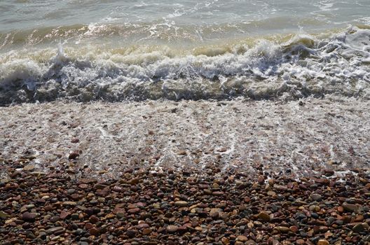 Detail of waves reaching the shore of the beach