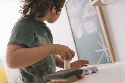 little girl looking her drawing in the blackboard at her room at home, copy space for text