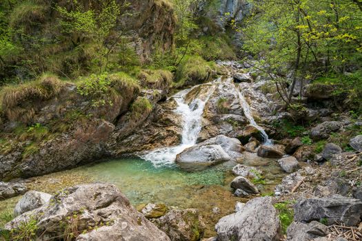 Beautiful view of the Vertova torrent at sunset, in the middle of the Orobiche mountains with its beautiful tiny waterfalls.