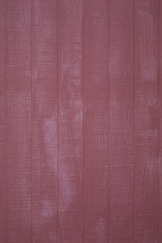 Exterion red barn wall, vertical planking, vertical format;