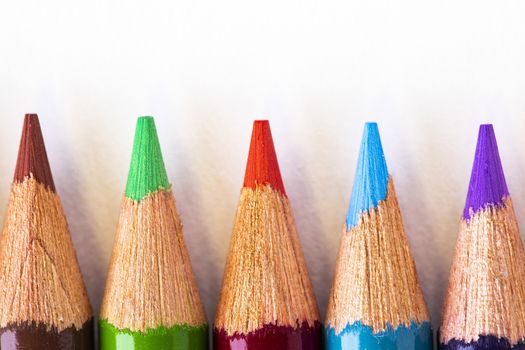 Closeup view of five sharpened color pencils.