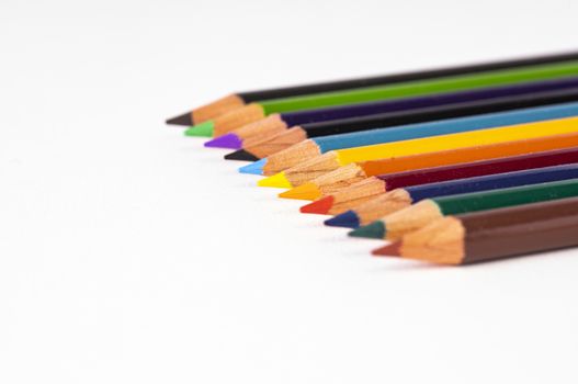 A group of colored pencils is shown with selective focus on center pencils.