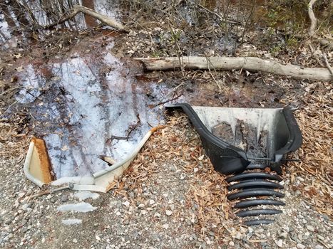 metal and plastic drain pipes with water and mud and leaves