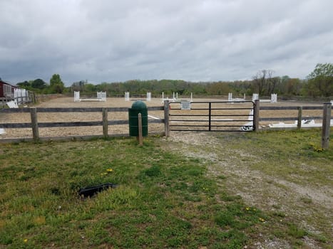 metal gate or door and garbage can at equestrian arena