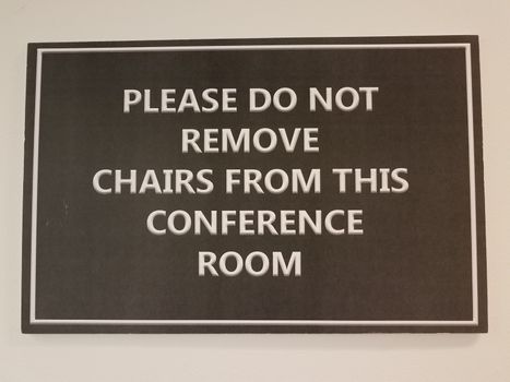 black please do not remove chairs from the conference room sign on white wall