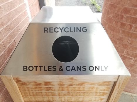 metal recycling bottles and cans only sign with hole on trash can