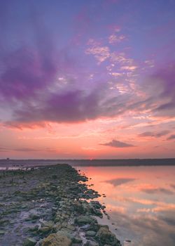 Sunset clouds over a drying salt lake