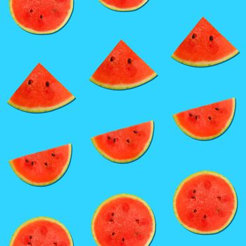 Seamless pattern of fresh red ripe juicy watermelon round cut wedges on vivid blue background