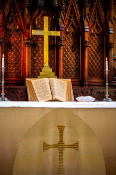Riga, Latvia - May 18, 2018. Riga Luther Church. Church altar with cross and bible before wedding ceremony. Open bible on altar before worship. Interior of church. 