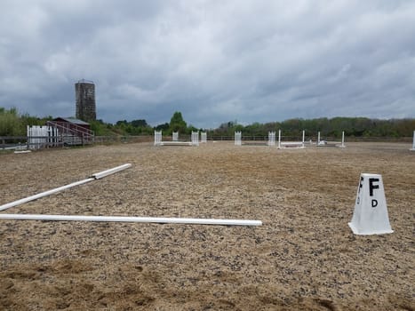 metal railings and sand or dirt at equestrian field or arena