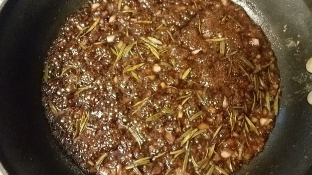 sweet brown fig and rosemary sauce cooking in frying pan or skillet
