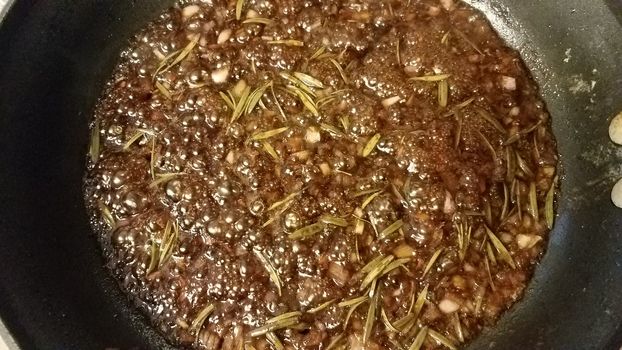 sweet brown fig and rosemary sauce cooking in frying pan or skillet