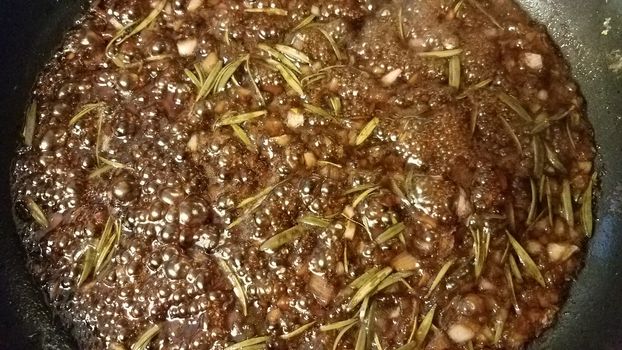 sweet brown fig and rosemary sauce cooking in frying pan or skillet