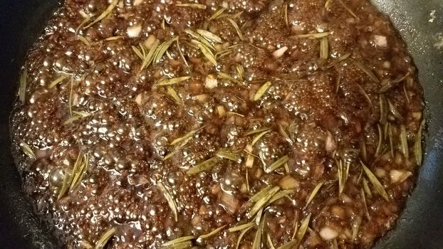 sweet brown fig and rosemary sauce cooking in frying pan or skillet