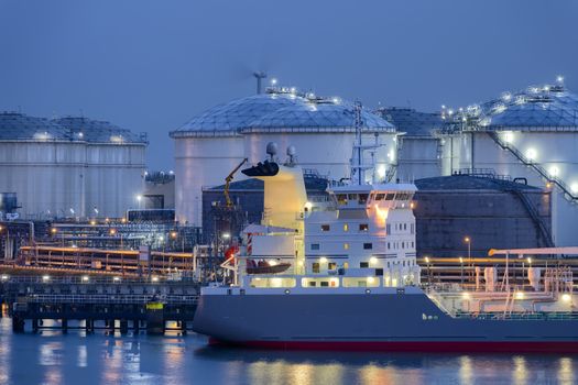 Liquid Natural Gas storage tanks and tanker at dusk, Port of Rotterdam