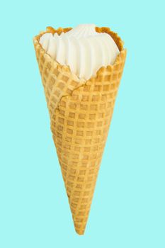 Vanilla ice cream in waffle conVanilla ice cream in waffle cone isolated on pastel blue background, vertical close-up framend,