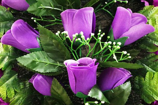 Background of bright purple tulips with leaves