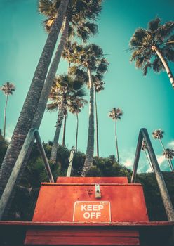 Retro Style Beach Image Of A Lifeguard Chair And Palm Trees At A Hawaiian Beach