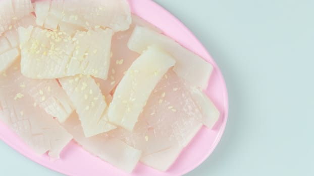 top view raw squid sliced on pink plate