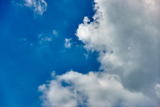 White cumulus cloud on blue sky as a background with copy space.