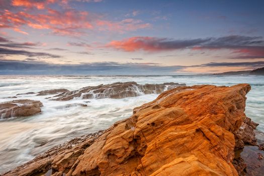 An ocean of emotion, its tempestuous waves surge and froth as the tide pulls them into the shore and they crash and cascade over rocks with fast fury.  A storm on the horizon at sunrise.