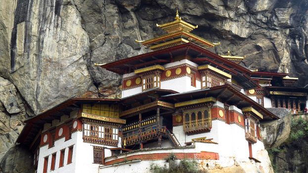 A closeup view of the entire Tigers Nest Monastery built in a high cliff over the valley in Paro, Bhutan                               