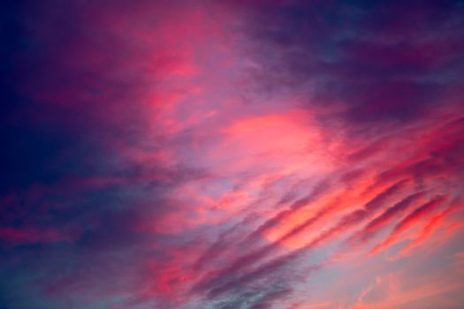Sunset clouds sky background. Blue, purple and red clouds on dramatic sunset sky