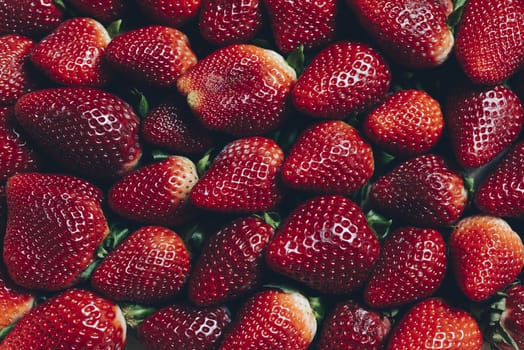 background image of red strawberries seen from above, healthy sweet food, vitamins and fruity concept. Food frame background, flat lay, top view point