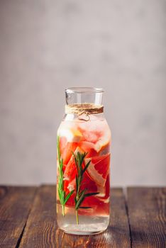 Summer Drink with Refreshing Raw Grapefruit and Fresh Rosemary. Vertical Orientation. Copy Space on the Top.