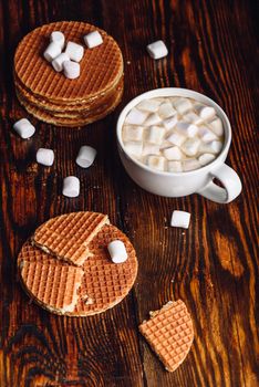 Homemade Dutch Waffles with Broken One with White Cup of Cocoa with Marshmallow and Waffle Stack. Vertical Orientation.