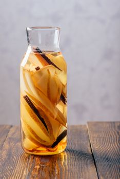 Water infused with Pear, Ginger Root and Cinnamon Stick. Vertical Orientation and Copy Space.