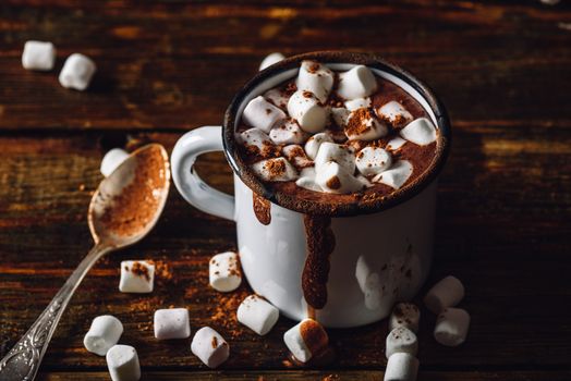 Cocoa Mug with Marshmallow. Some Marshmallow and Cocoa Powder Scattered on Wooden Table.