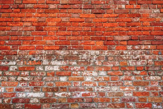 Old chipped wall of red brick. Background.
