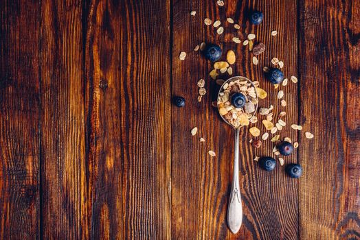 Spoonful of Granola and Blueberry on Wooden Table. View from Above. Copy Space on the Left.