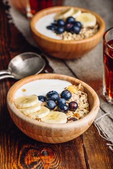 Two Bowl of Granola with Banana, Blueberry and Greek Yogurt for Breakfast. Vertical Orientation.