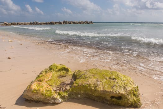 Granite rocks and ocean water in a Cancun beach, Mexico.