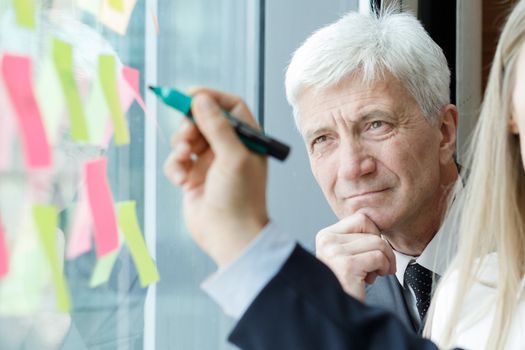 Group of business people brainstorming ideas. Entrepreneurs having a standing meeting discussing ideas strategy planning problem solution concept