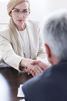 Business people shaking hands at meeting table