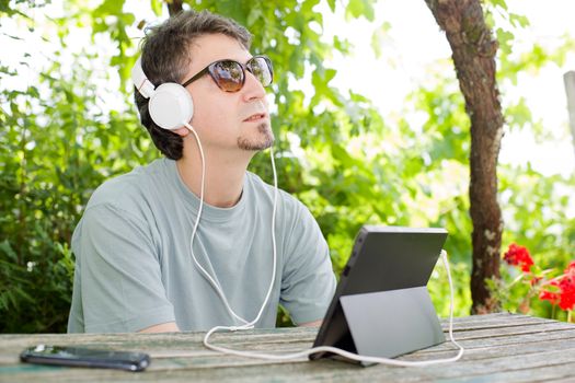 casual man working with a tablet pc, outdoor